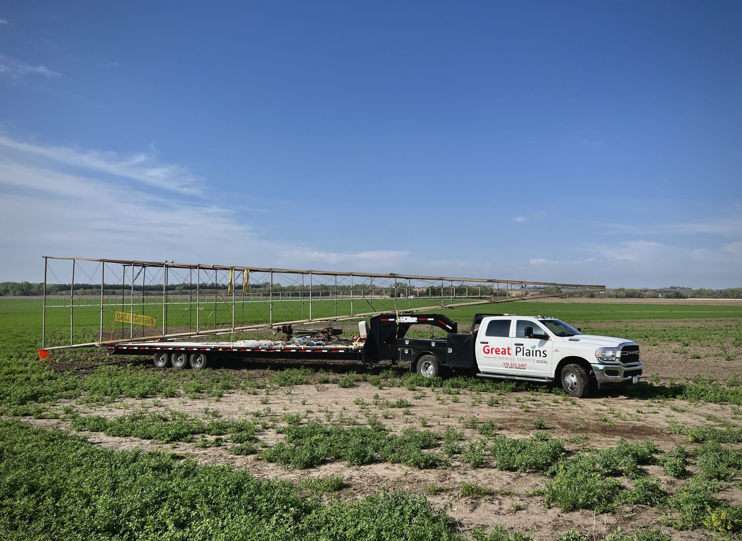 Great Plains Truck in a field installing a new windmill | Great Plains Windmill Service